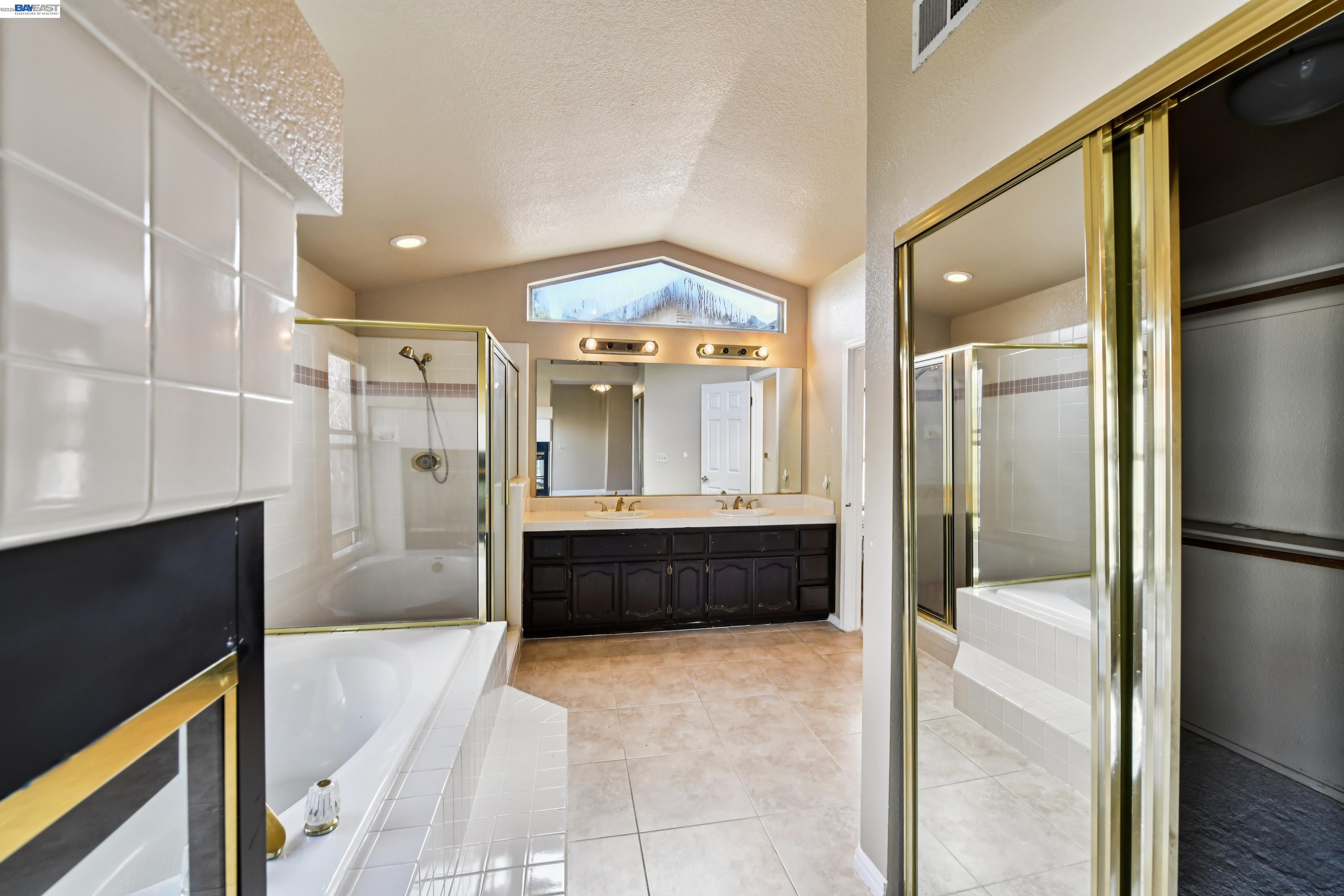 110 Conductor Way Folsom, CA 95630 - Photo 21 of 27 a bathroom with a tub a sink a mirror and a shower