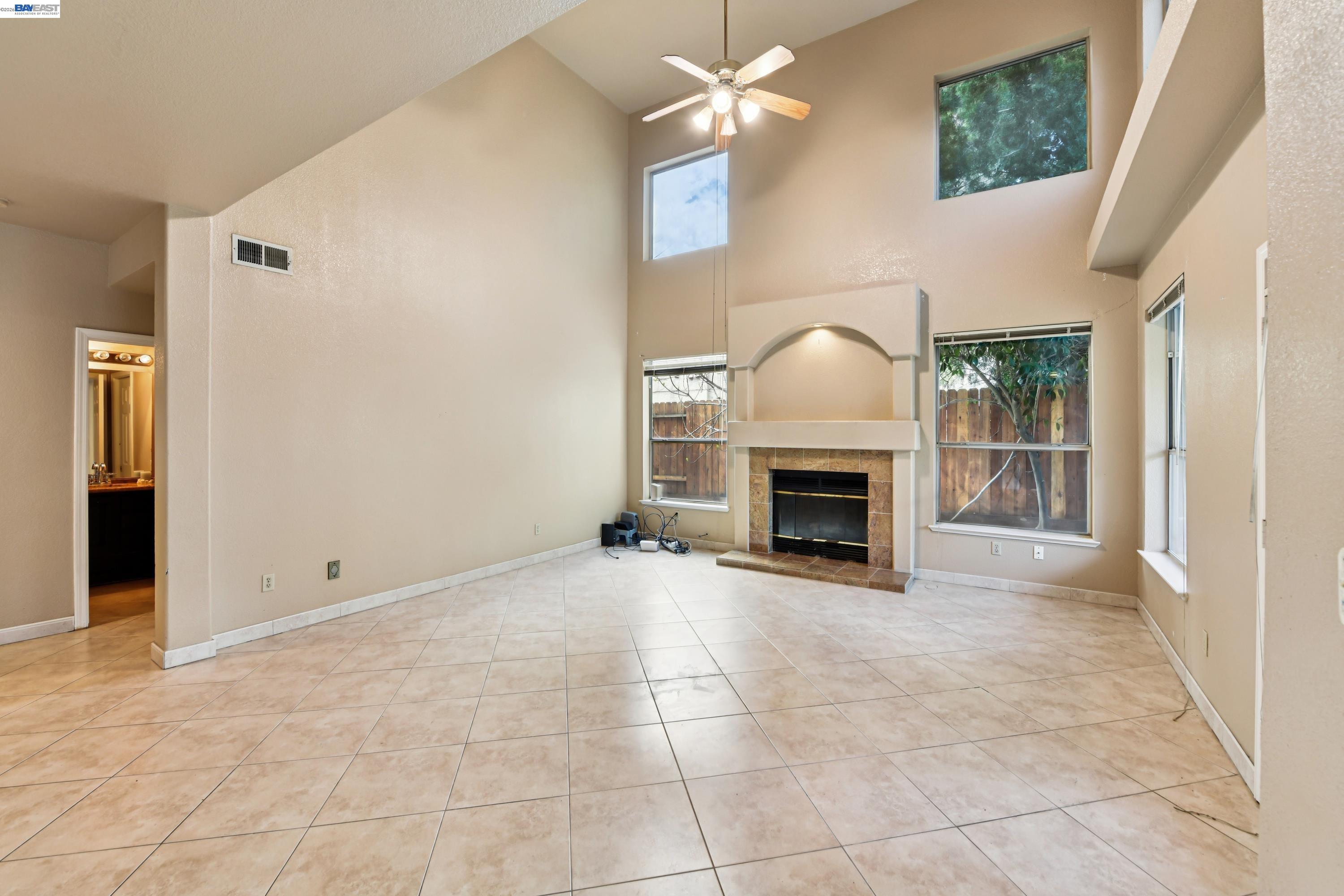 110 Conductor Way Folsom, CA 95630 - Photo 7 of 27 a view of a livingroom with a fireplace a ceiling fan and windows