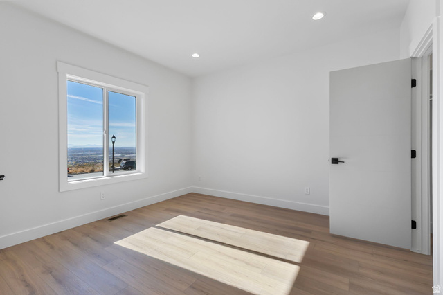 710 East Mountain Road North Ogden, UT 84414 - Photo 19 of 36 Unfurnished room featuring light wood-type flooring and recessed lighting