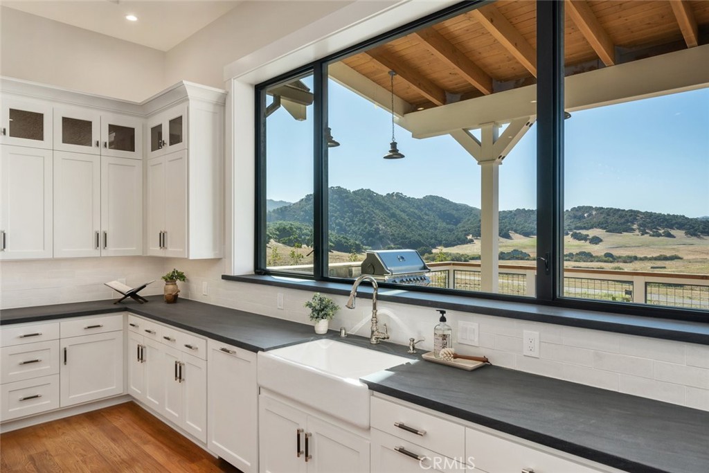 610 Spanish Springs Drive San Luis Obispo, CA 93401 - Photo 19 of 75 a kitchen with a large window sink and cabinets
