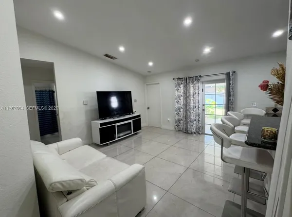 a living room with furniture and a flat screen tv