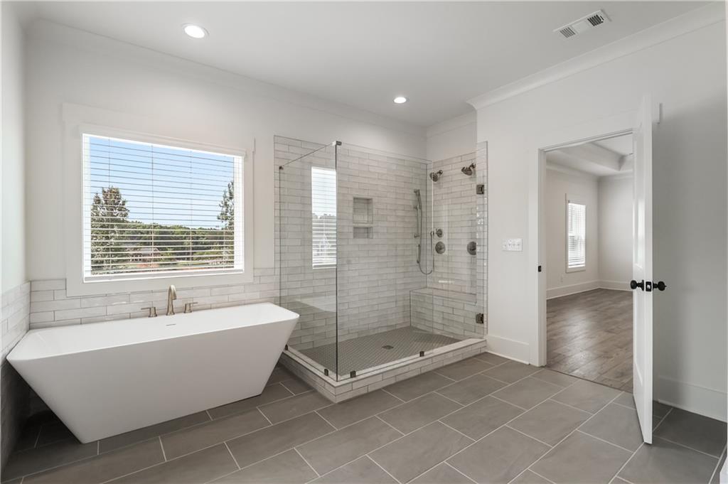 2113 Stonegate Way Monroe, GA 30656 - Photo 30 of 43 a bathroom with a bathtub and shower