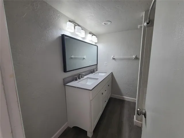 a bathroom with a sink a mirror and a toilet