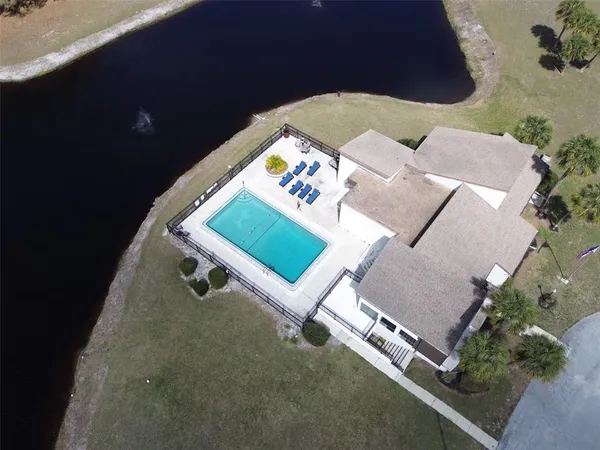 a lawn chairs sitting in a backyard with pool