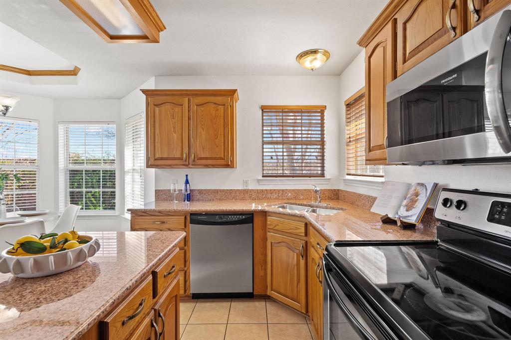623 Madison Place Sherman, TX 75092 - Photo 13 of 37 a kitchen that has a sink and a stove