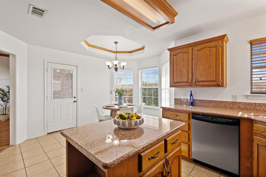 623 Madison Place Sherman, TX 75092 - Photo 14 of 37 a kitchen with stainless steel appliances granite countertop a sink a stove and a refrigerator