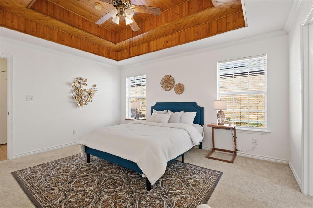 623 Madison Place Sherman, TX 75092 - Photo 16 of 37 a bedroom with a bed and a table in it