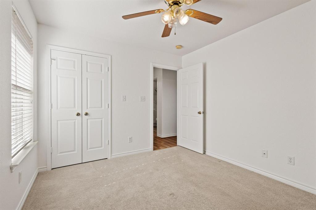 623 Madison Place Sherman, TX 75092 - Photo 25 of 37 an empty room with a chandelier fan and windows