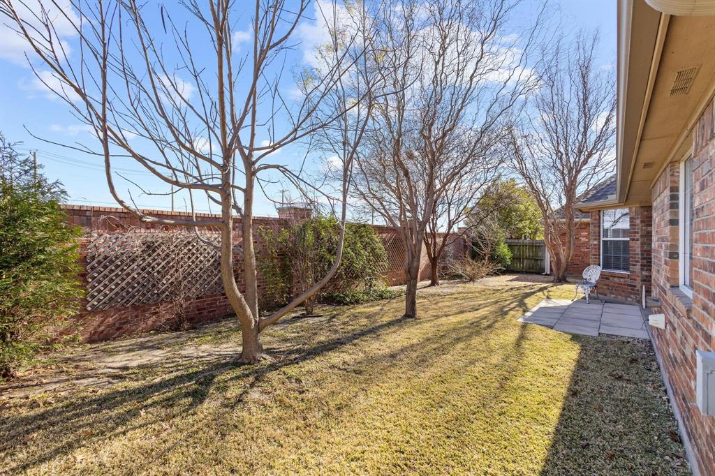 623 Madison Place Sherman, TX 75092 - Photo 32 of 37 a view of a yard with plants and trees