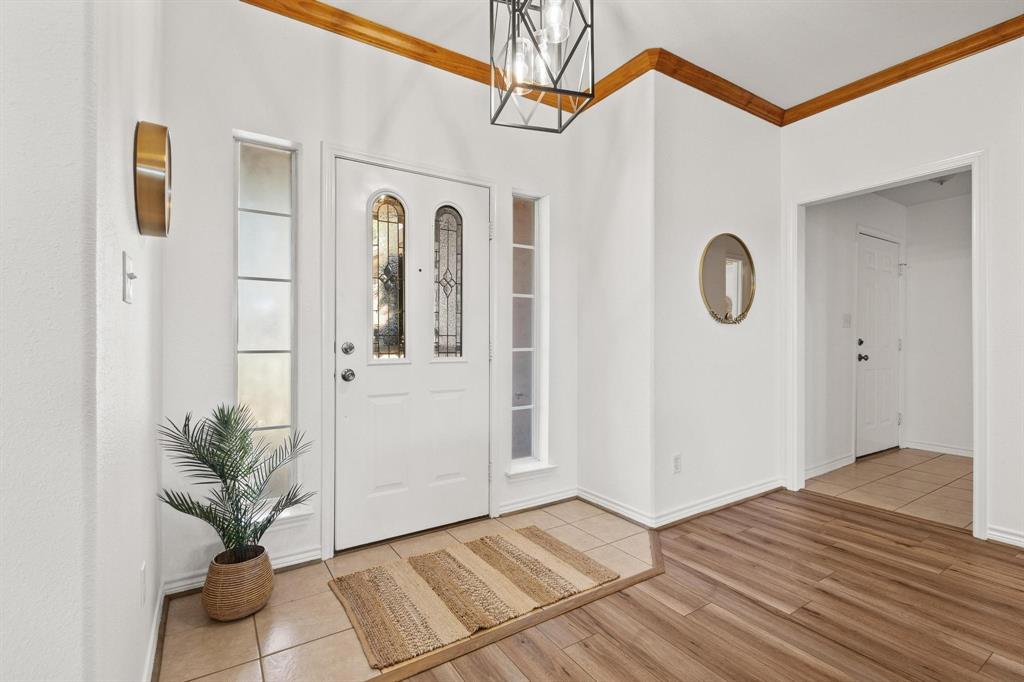 623 Madison Place Sherman, TX 75092 - Photo 4 of 37 a view of a hallway with entryway wooden floor and front door