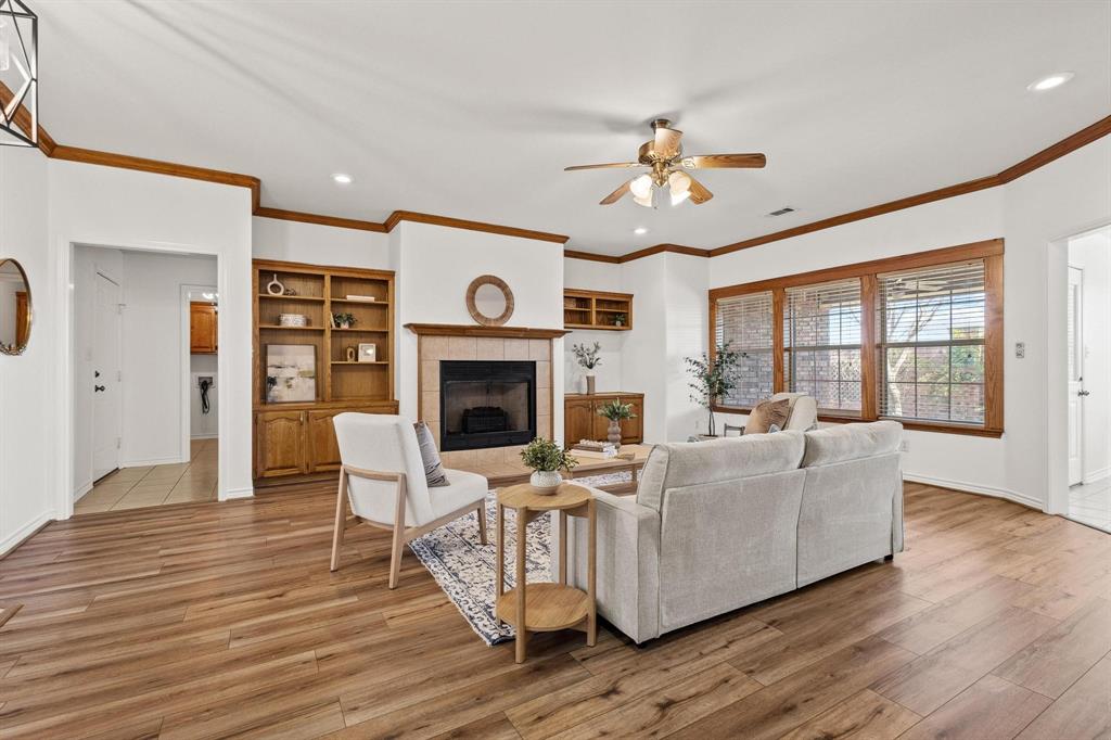 623 Madison Place Sherman, TX 75092 - Photo 5 of 37 a living room with furniture a fireplace and a ceiling fan