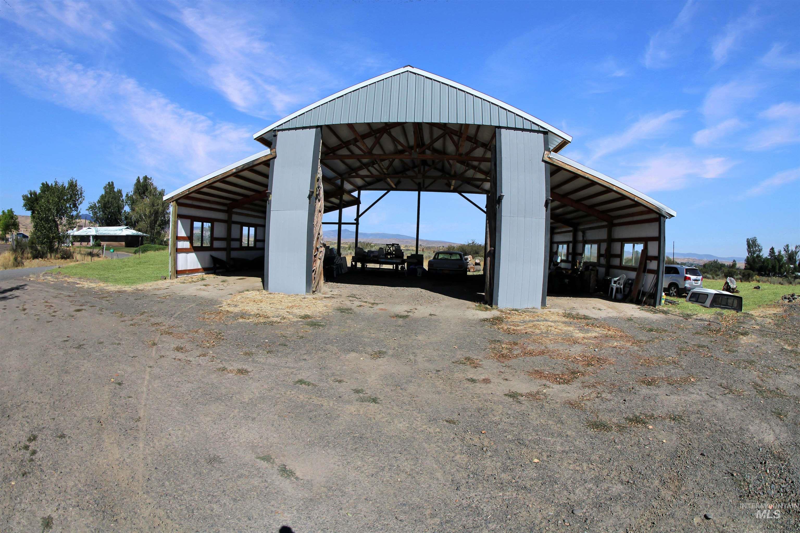 2110 Sage Creek Road Midvale, ID 83645 - Photo 26 of 42 Open-sided structure with exposed wood framing, multiple windows, and a sloped roof