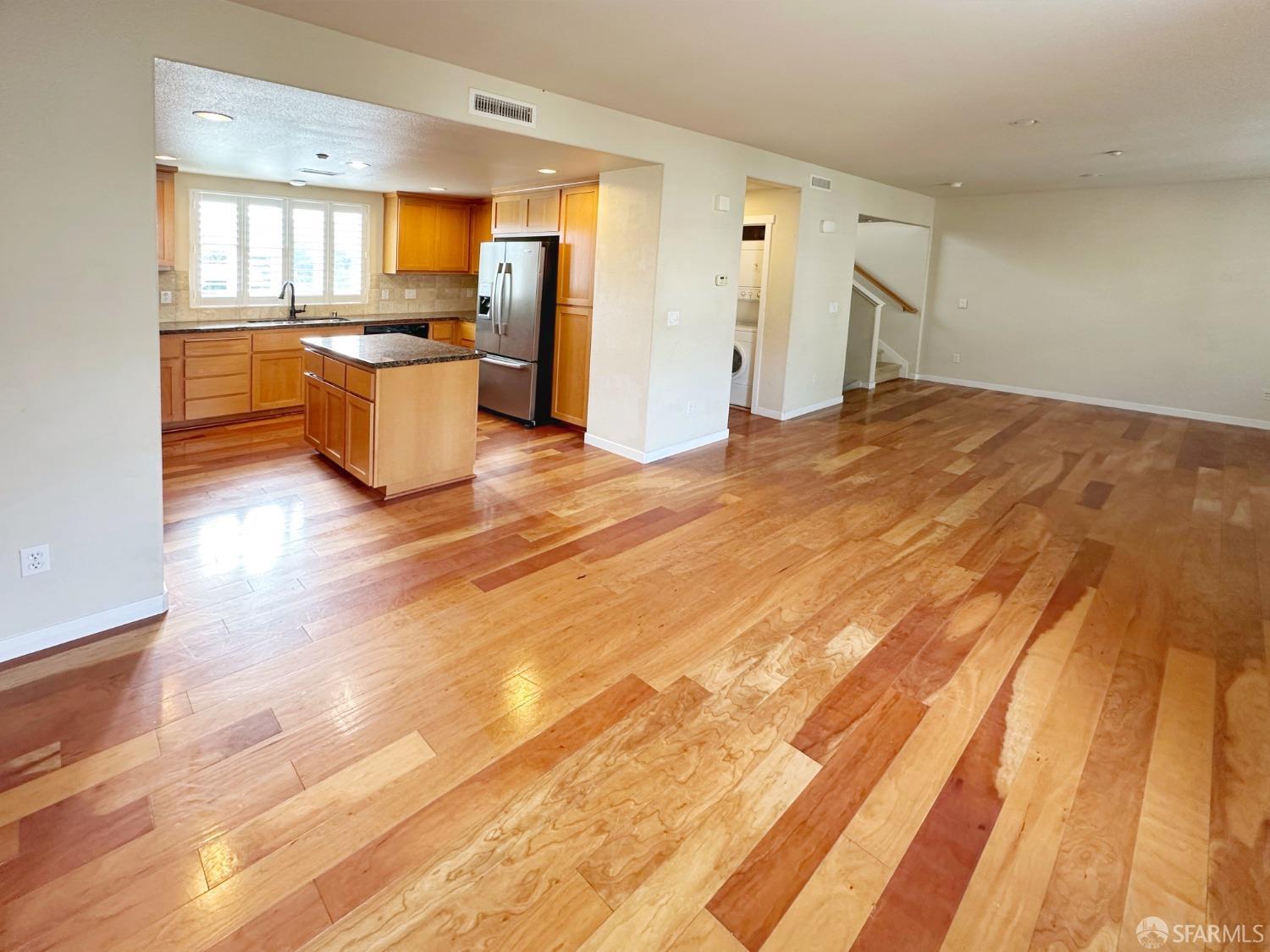 a view of a kitchen with wooden floor