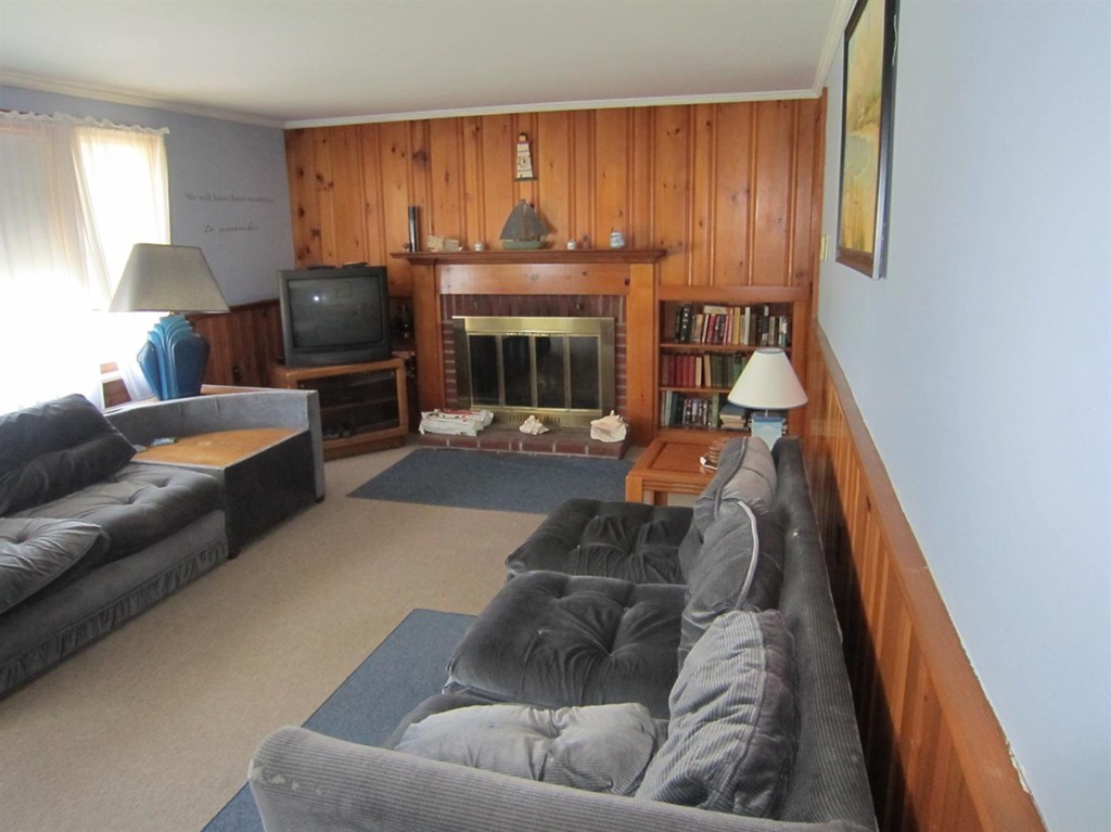 11 Wixon Road Dennis, MA 02639 - Photo 6 of 13 a living room with furniture and a fireplace