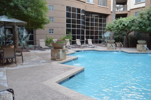 1701 East Colter Street, Unit 454 Phoenix, AZ 85016 - Photo 11 of 40 a view of a patio with table and chairs and potted plants