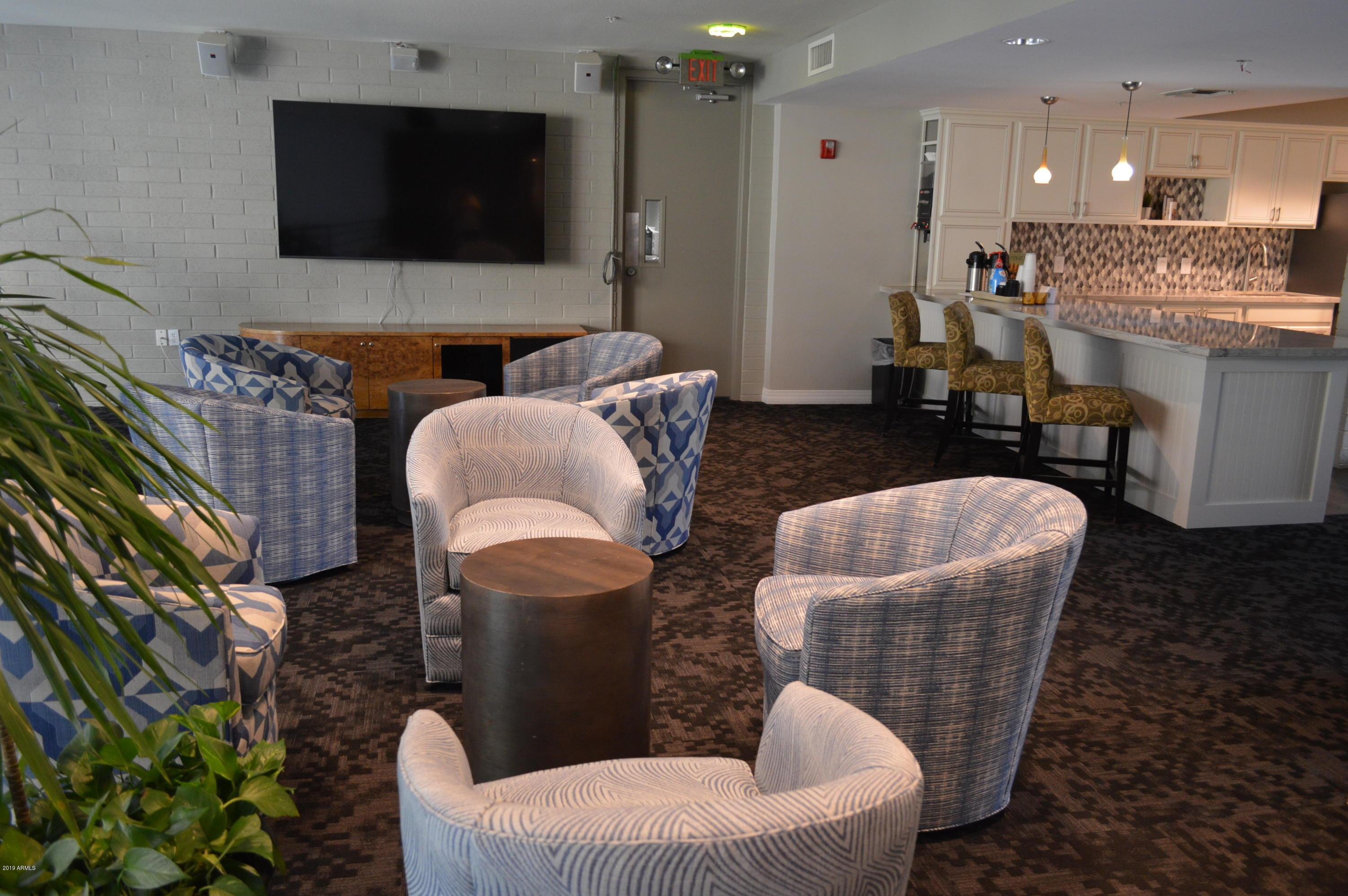 1701 East Colter Street, Unit 454 Phoenix, AZ 85016 - Photo 14 of 40 a living room with furniture and a flat screen tv