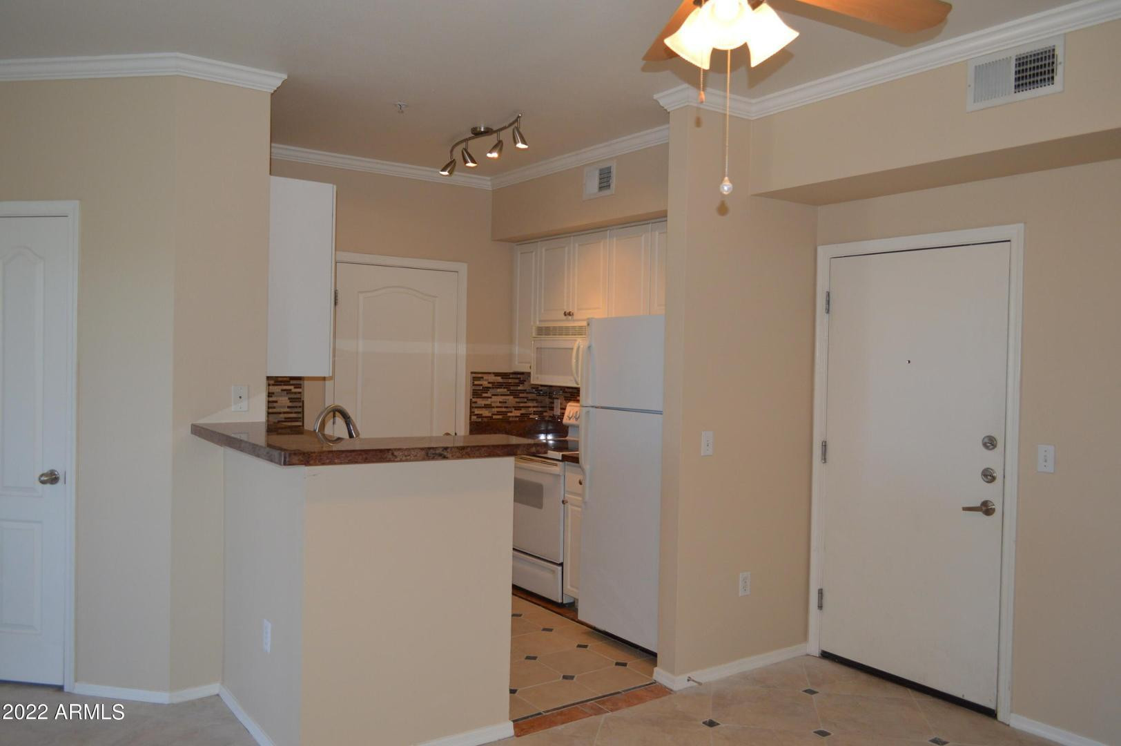 1701 East Colter Street, Unit 454 Phoenix, AZ 85016 - Photo 22 of 40 a kitchen with stainless steel appliances a refrigerator and a chandelier