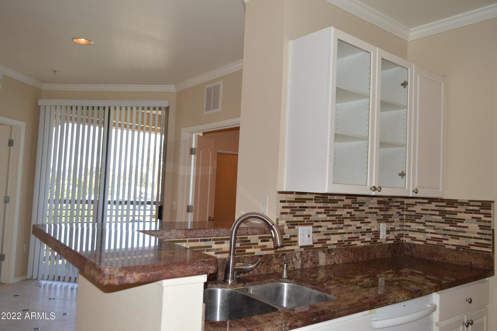 1701 East Colter Street, Unit 454 Phoenix, AZ 85016 - Photo 28 of 40 a kitchen with granite countertop a sink and a window