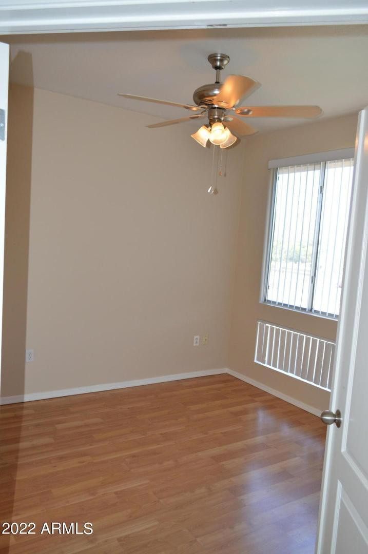 1701 East Colter Street, Unit 454 Phoenix, AZ 85016 - Photo 36 of 40 a view of an empty room with window and wooden floor