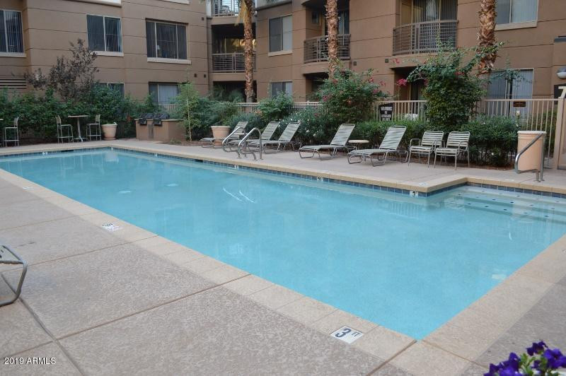 1701 East Colter Street, Unit 454 Phoenix, AZ 85016 - Photo 10 of 40 a view of building with swimming pool and outdoor seating