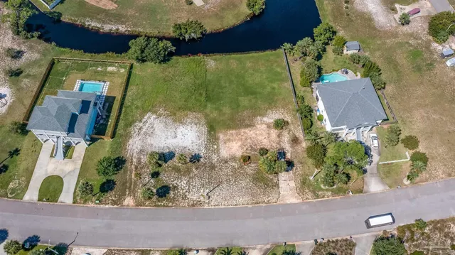 an aerial view of a residential houses with outdoor space