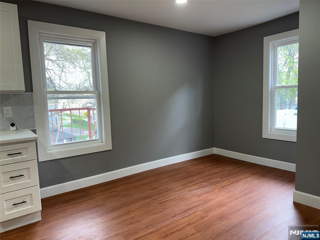 178 Berry Street Hackensack, NJ 07601 - Photo 13 of 22 a view of an empty room with wooden floor and a window