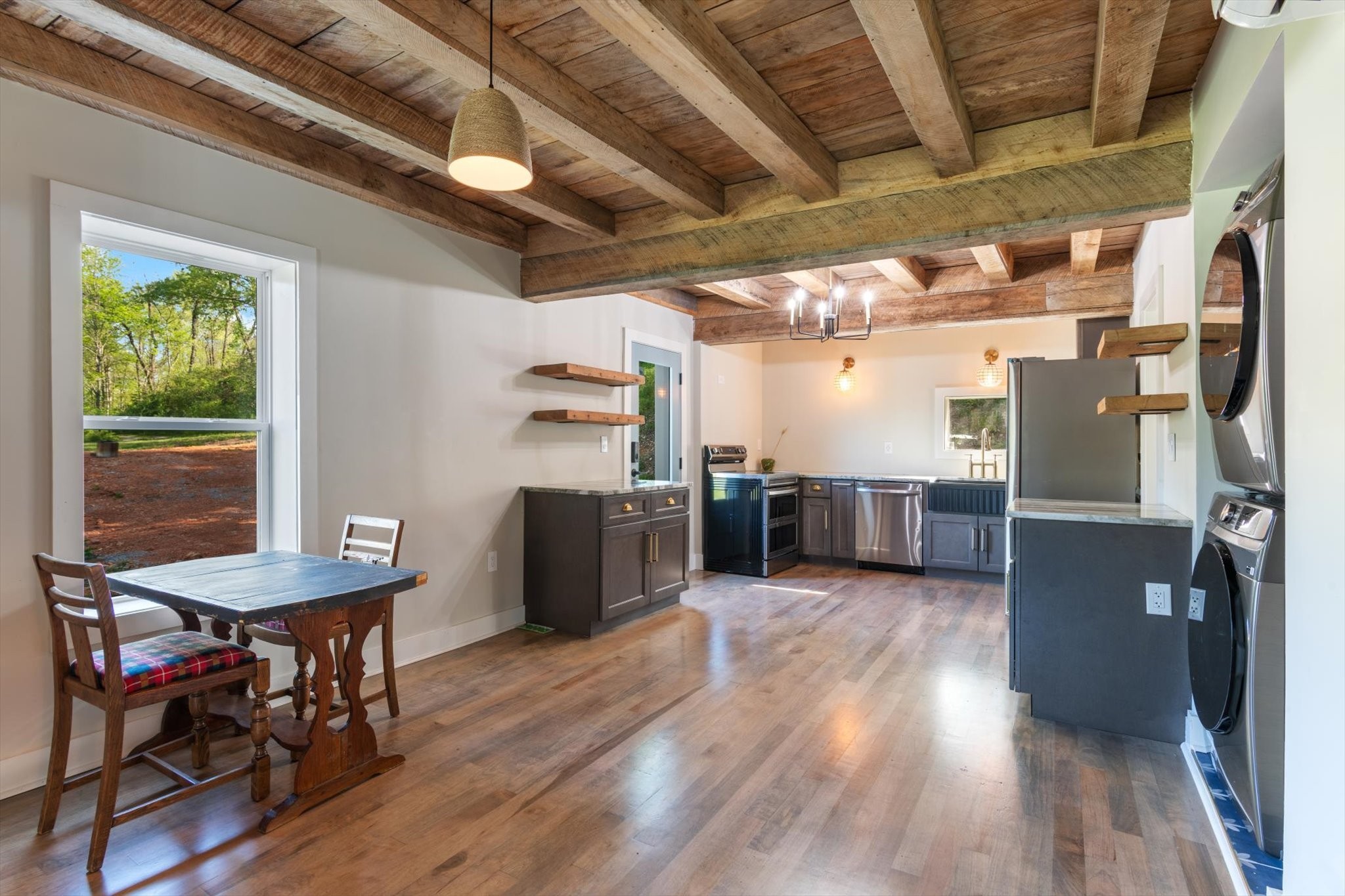 8315 West Sheepneck Road Mount Pleasant, TN 38474 - Photo 8 of 24 a kitchen with stainless steel appliances kitchen island granite countertop a table chairs and a refrigerator