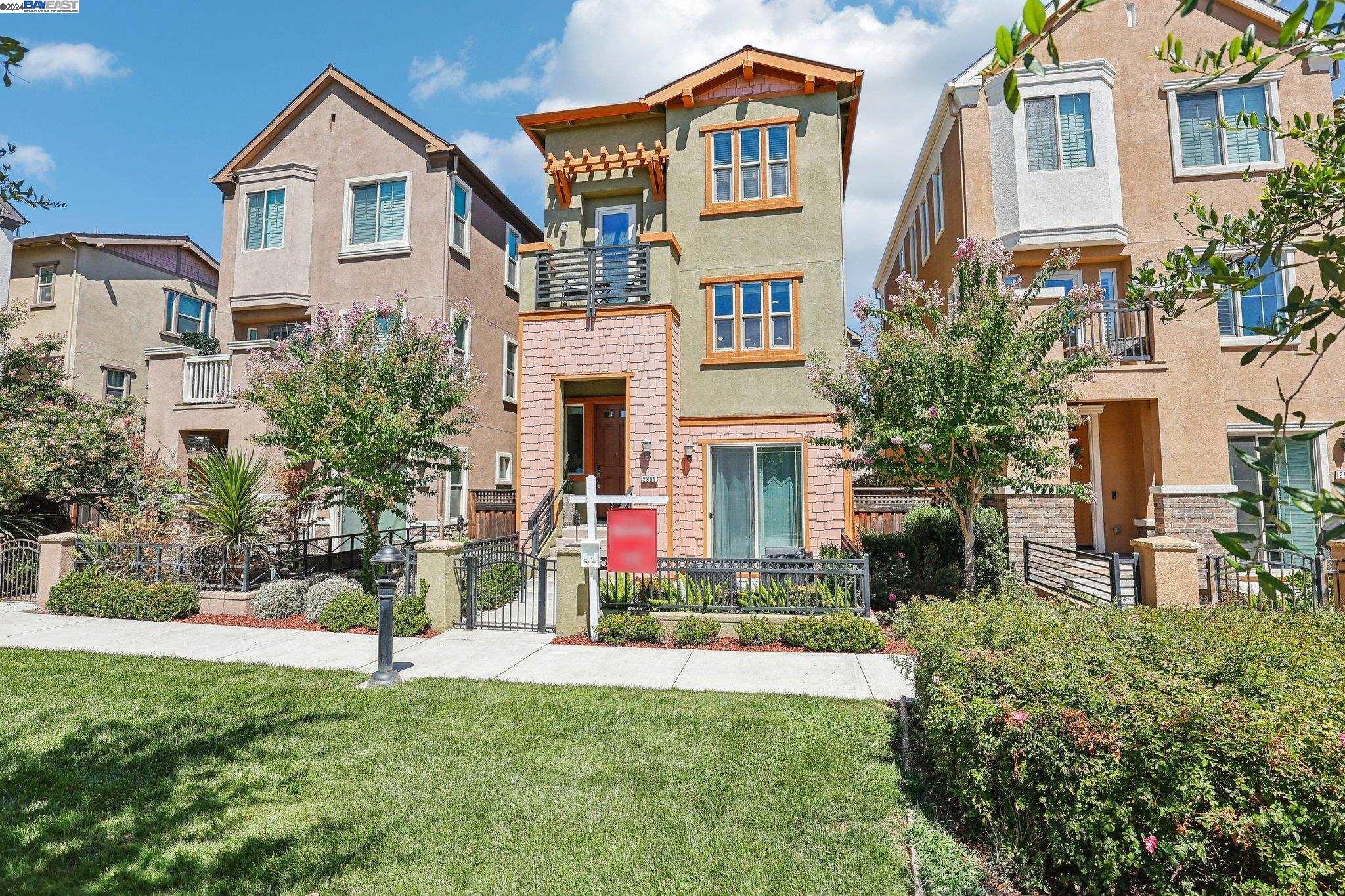 a front view of a house with a yard and trees