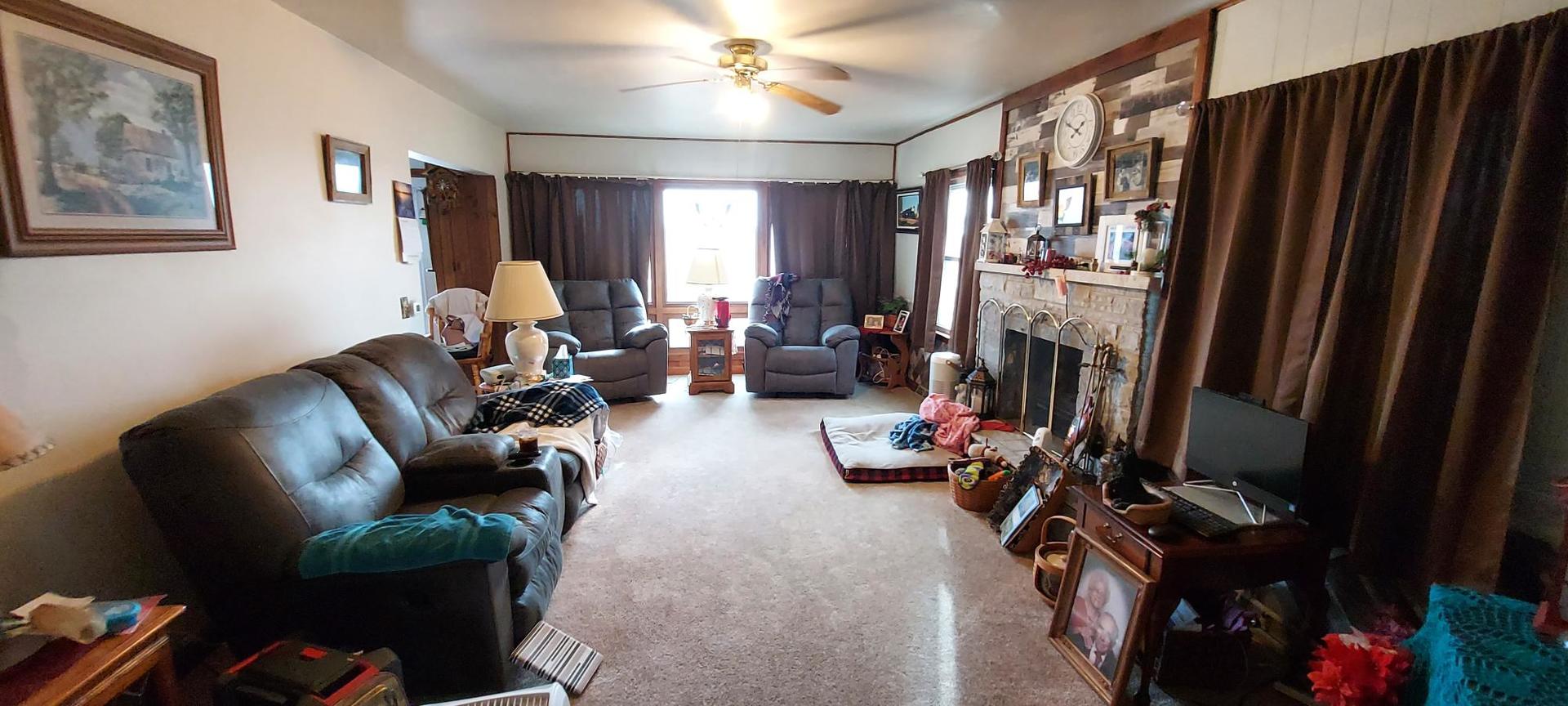 1640 170th Avenue Reynolds, IL 61279 - Photo 15 of 33 a living room with furniture gym equipment and a large window
