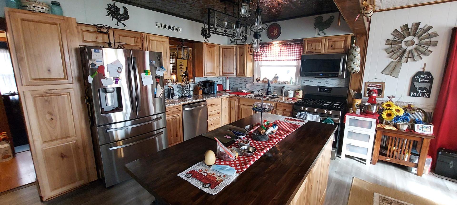 1640 170th Avenue Reynolds, IL 61279 - Photo 9 of 33 a kitchen with stainless steel appliances granite countertop a refrigerator a stove top oven a sink and dishwasher
