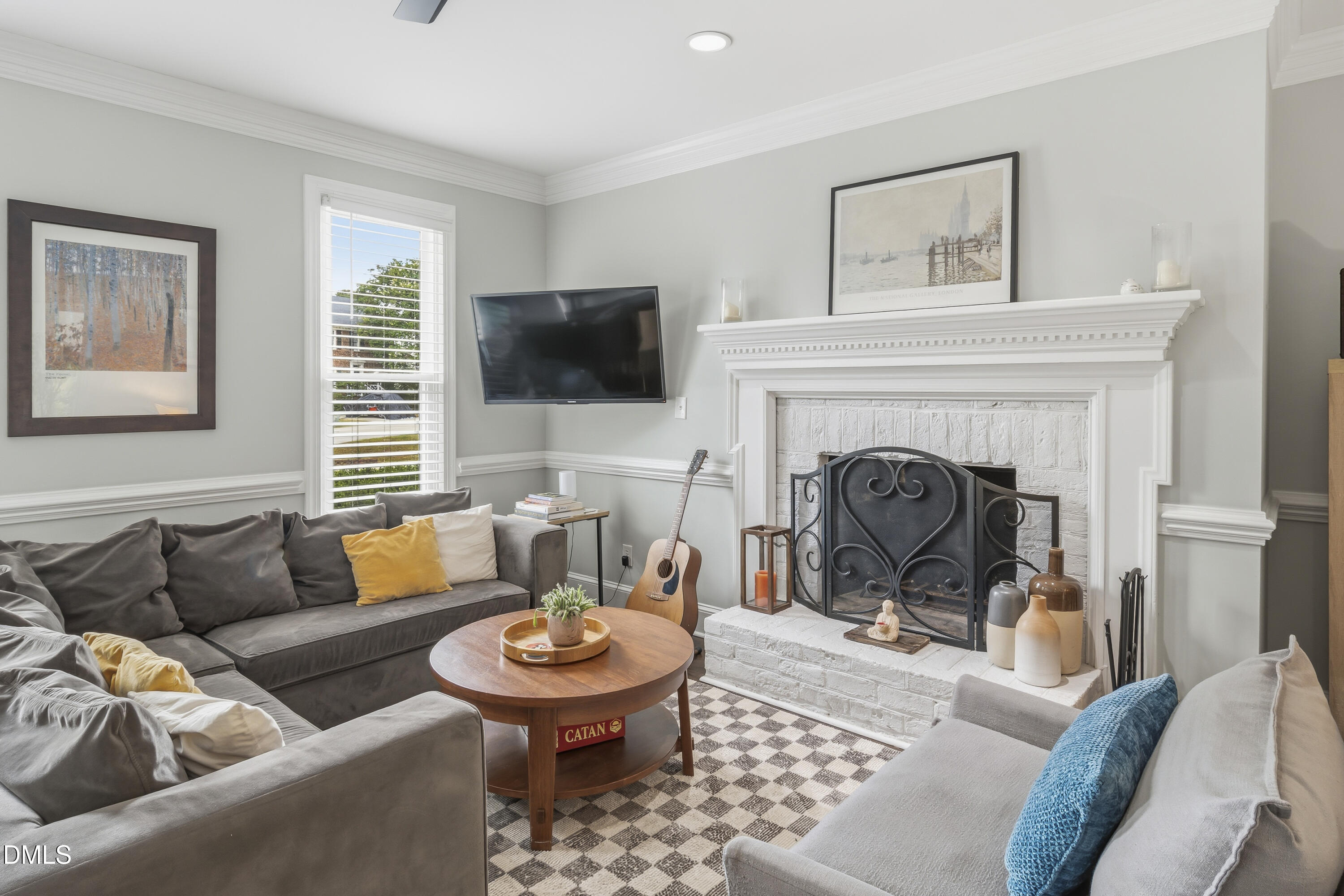 3004 West Annaley Drive Raleigh, NC 27604 - Photo 13 of 44 a living room with furniture a fireplace and a flat screen tv