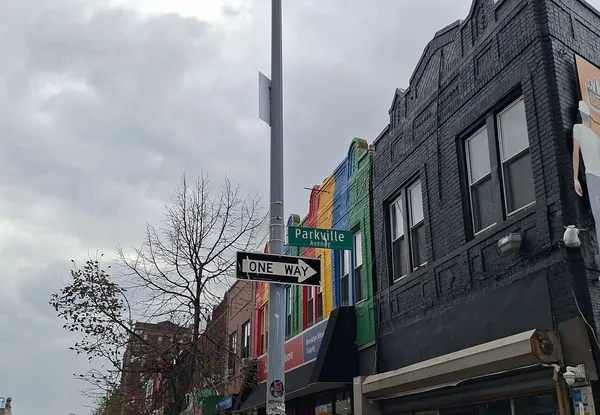 a couple of cars parked in front of a building