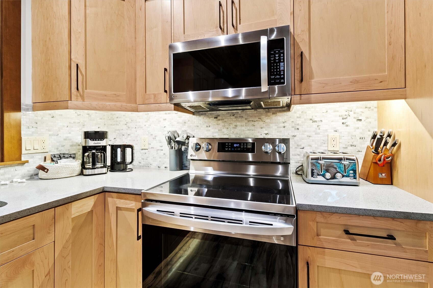 7381 Scott Place Deming, WA 98244 - Photo 12 of 40 a kitchen with stainless steel appliances a stove a microwave and cabinets