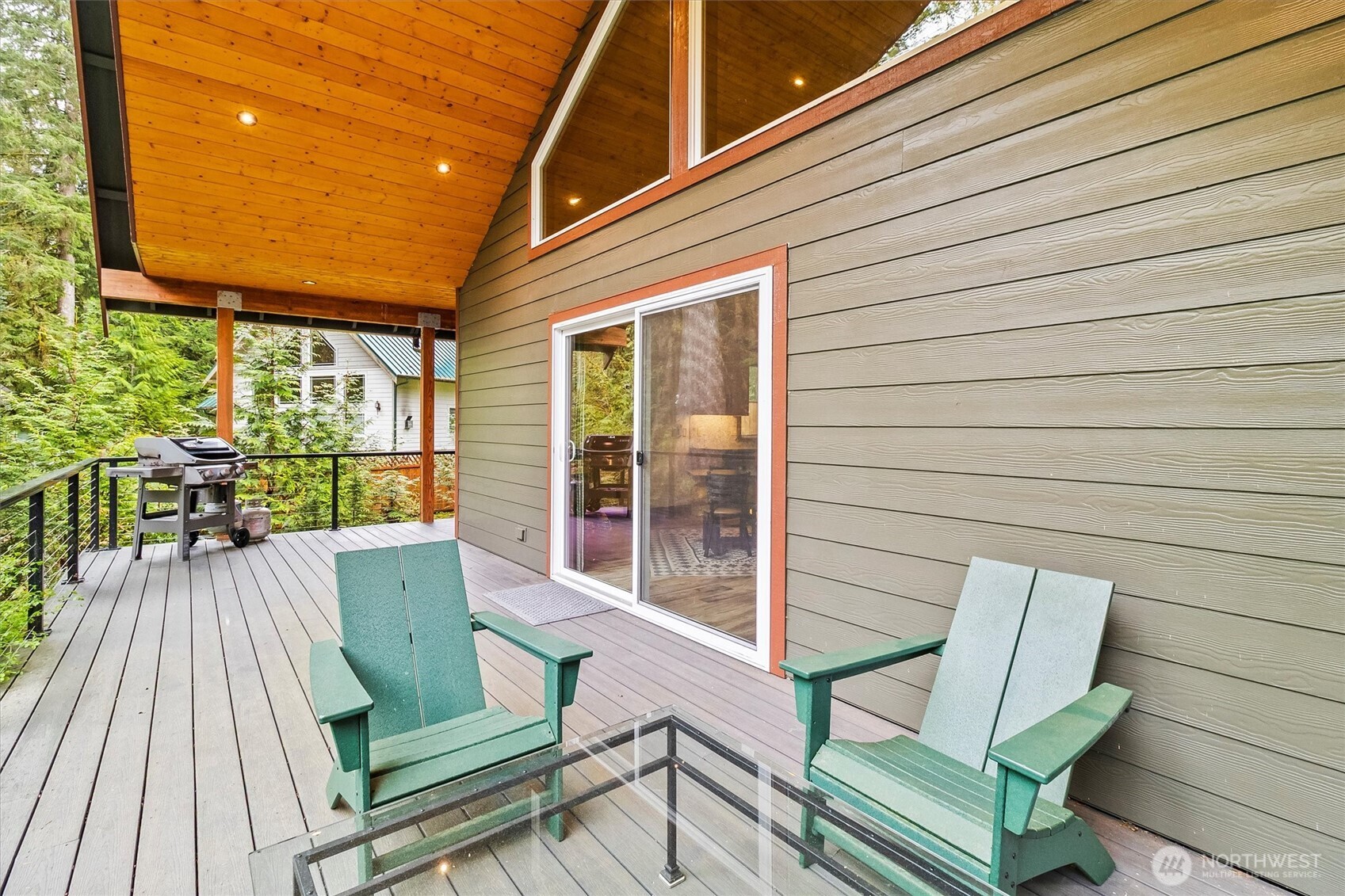 7381 Scott Place Deming, WA 98244 - Photo 25 of 40 a view of a patio with table and chairs with wooden floor and fence