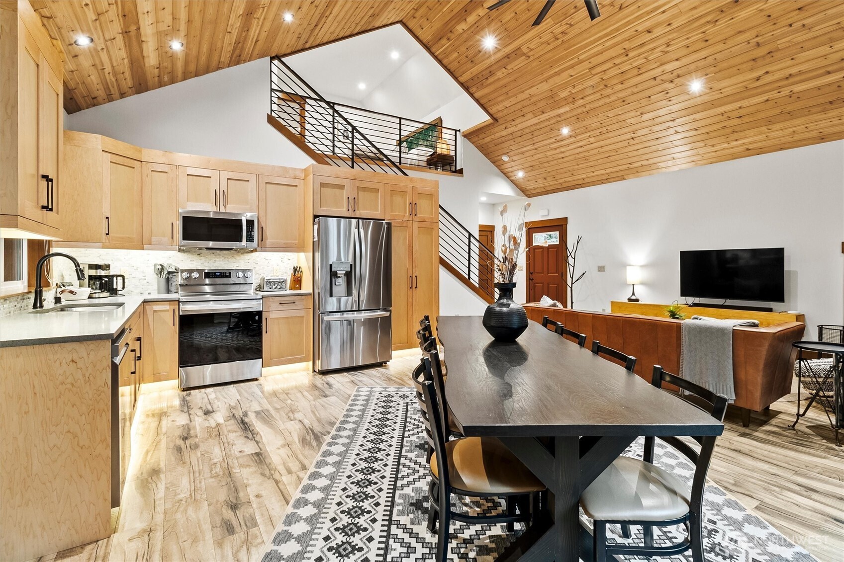 7381 Scott Place Deming, WA 98244 - Photo 9 of 40 a kitchen with stainless steel appliances kitchen island granite countertop a table chairs microwave and sink