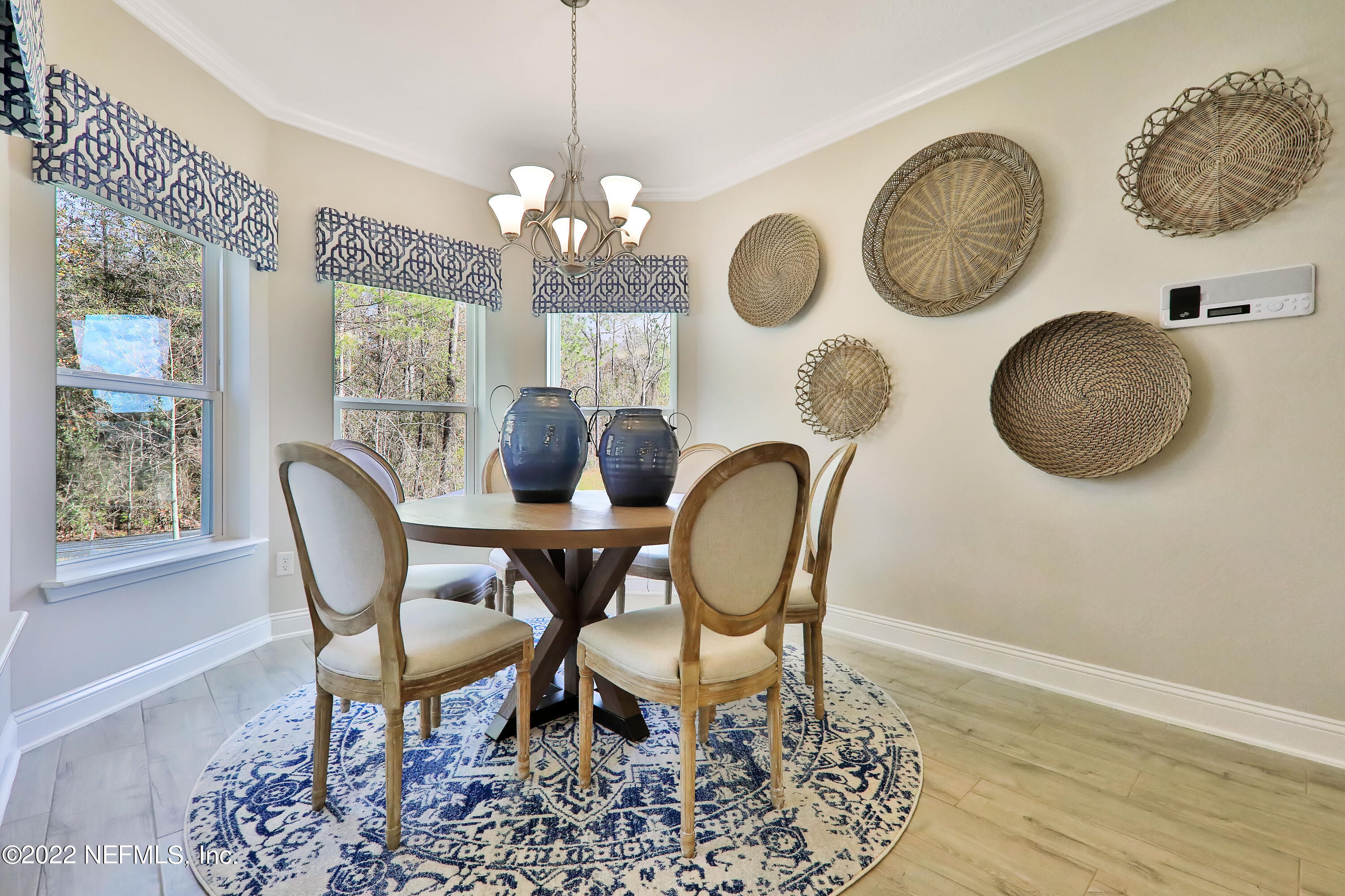 608 Ivory Palm Road Orange Park, FL 32073 - Photo 19 of 33 a dining room with chandelier fan and wooden floor
