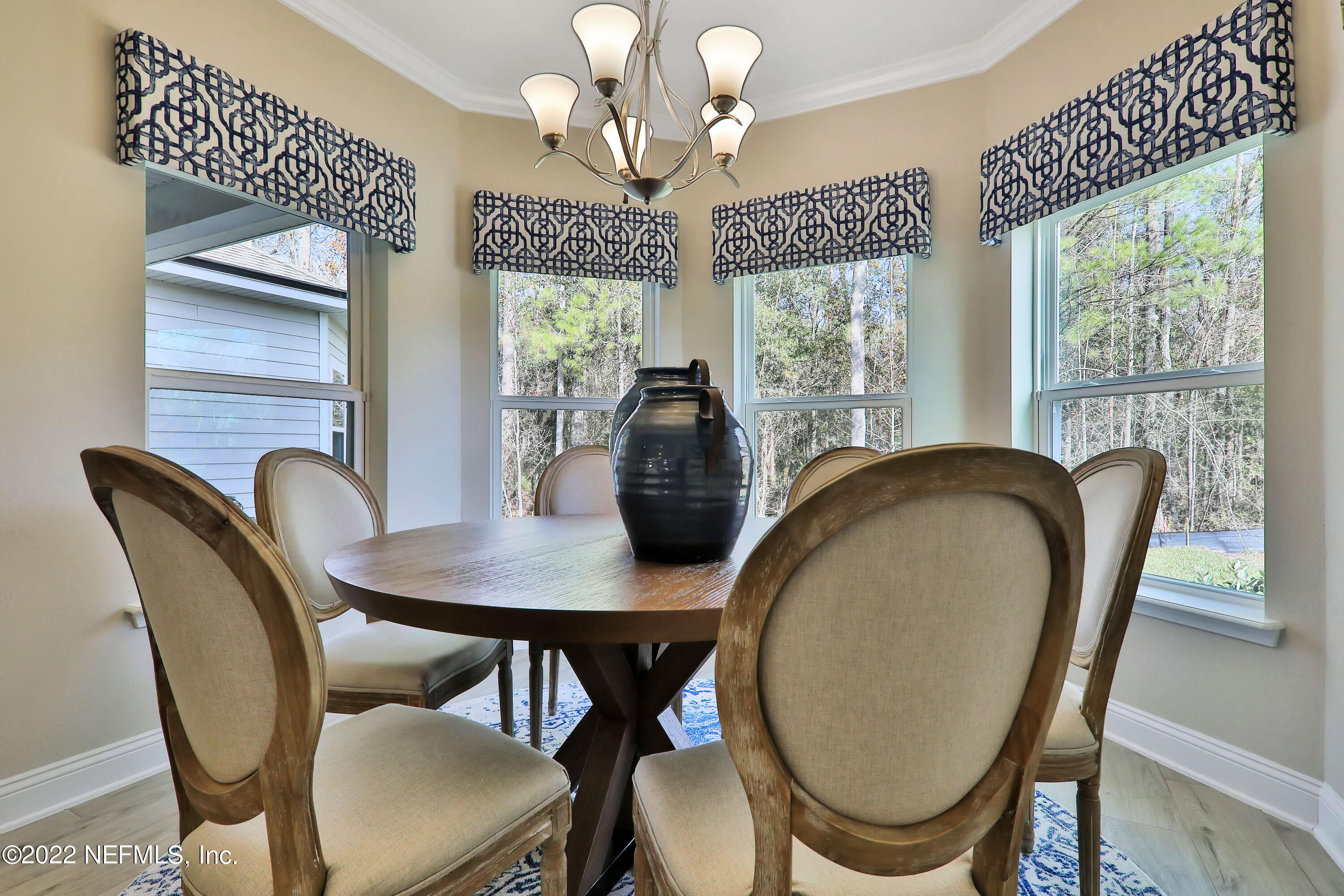 608 Ivory Palm Road Orange Park, FL 32073 - Photo 20 of 33 a view of a dining room with furniture wooden floor and chandelier