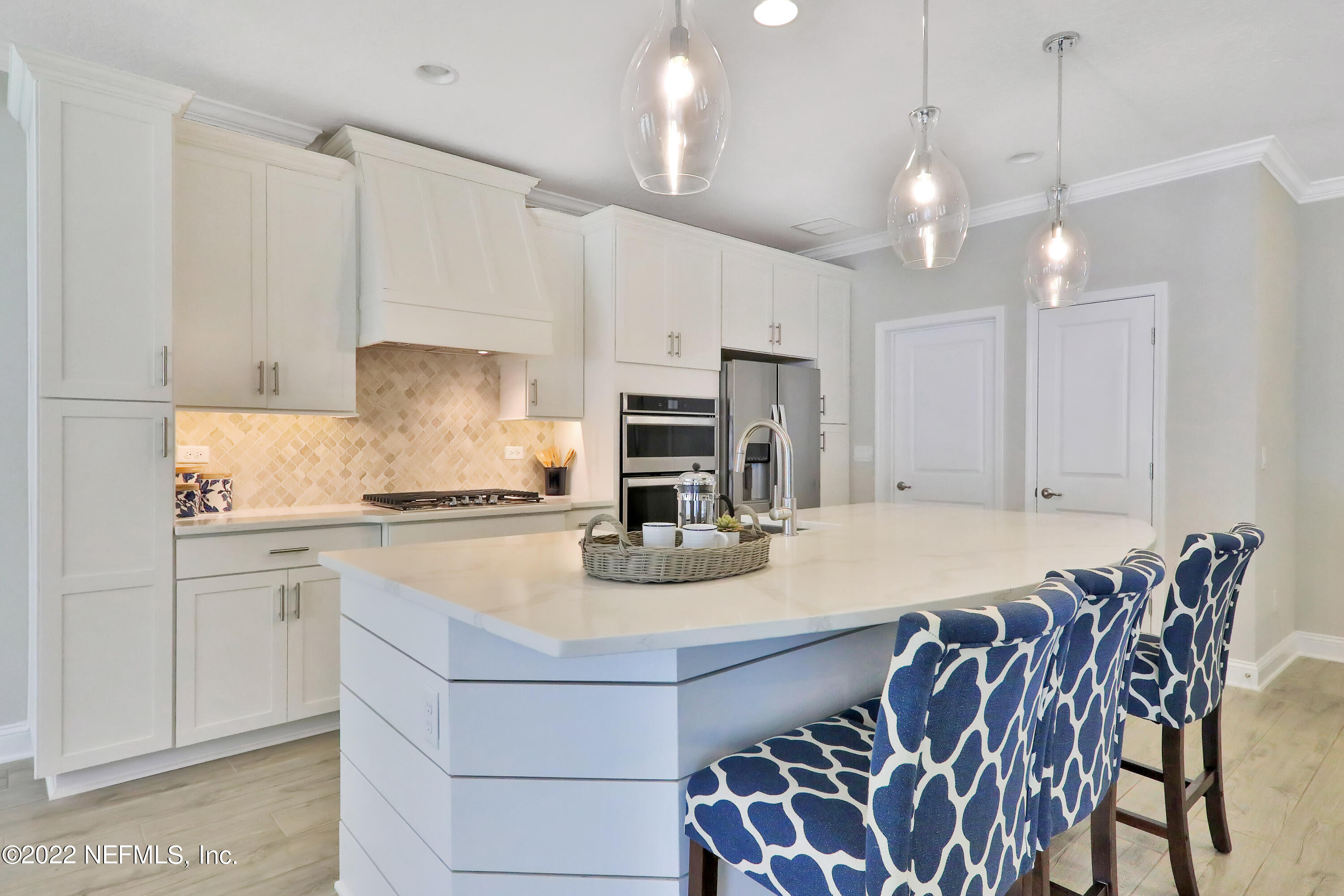 608 Ivory Palm Road Orange Park, FL 32073 - Photo 21 of 33 a kitchen with kitchen island a stove a chandelier and a refrigerator