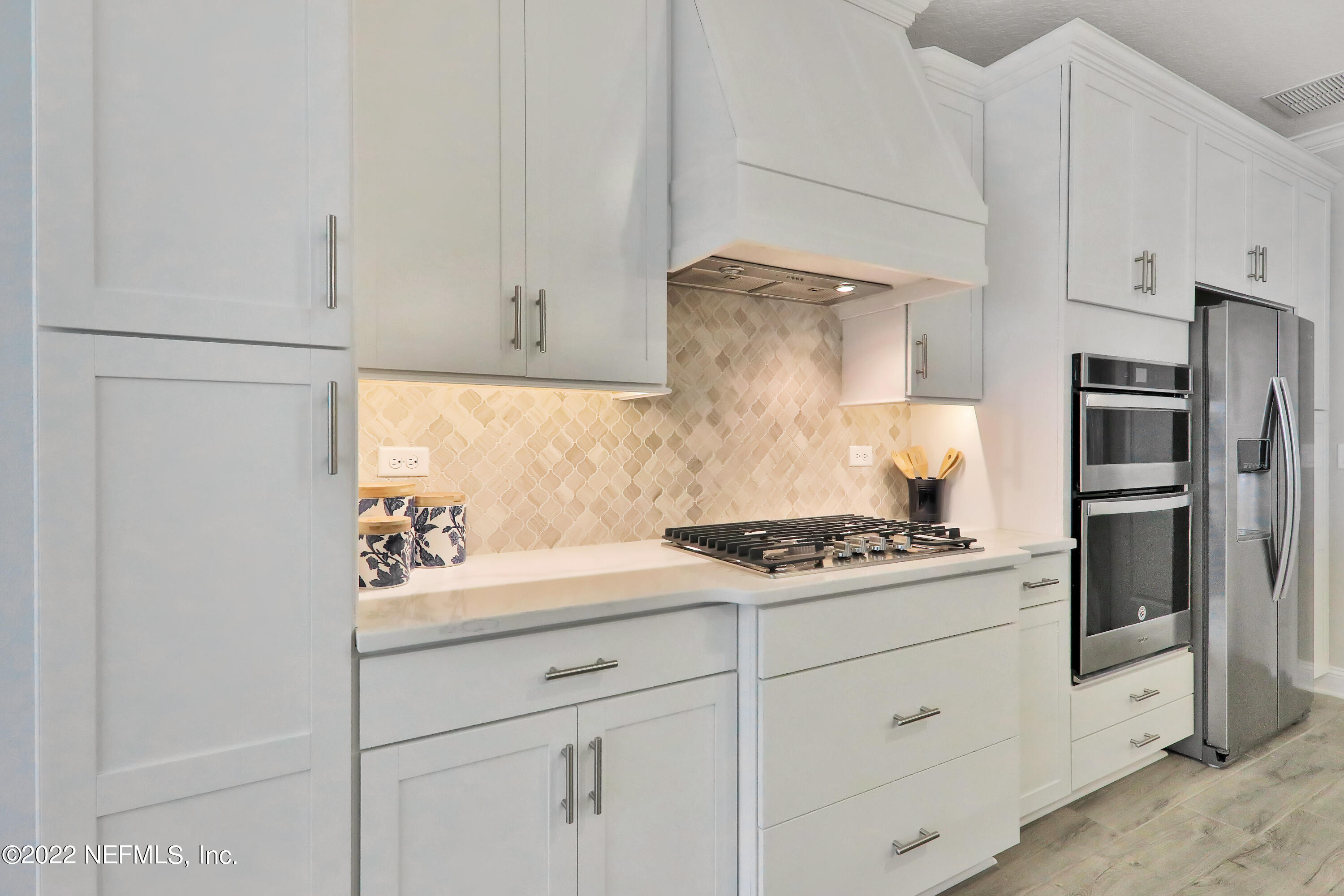 608 Ivory Palm Road Orange Park, FL 32073 - Photo 22 of 33 a kitchen with white cabinets and appliances