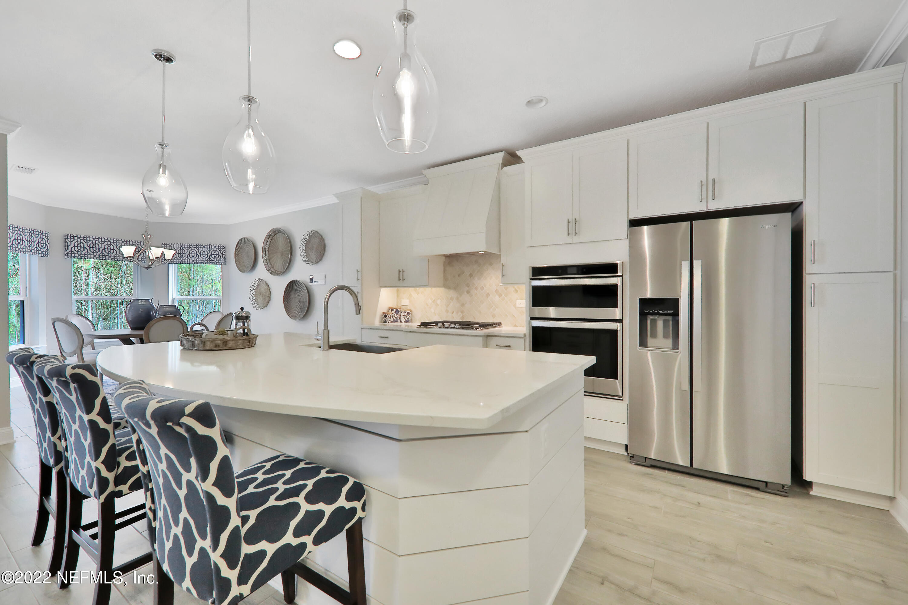 608 Ivory Palm Road Orange Park, FL 32073 - Photo 26 of 33 a kitchen with stainless steel appliances kitchen island a table chairs sink and cabinets