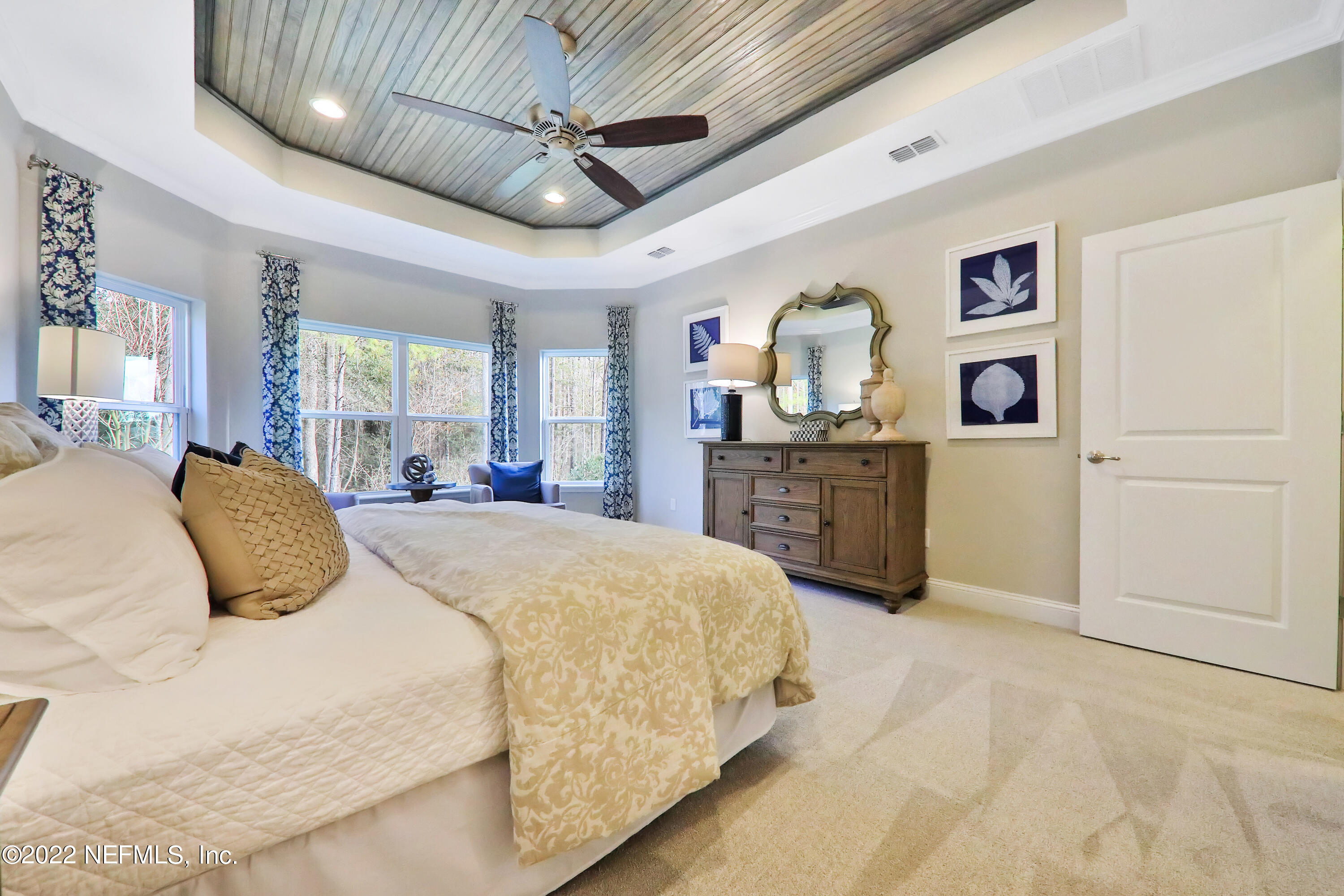 608 Ivory Palm Road Orange Park, FL 32073 - Photo 6 of 33 a spacious bedroom with a bed painting on wall and a large window