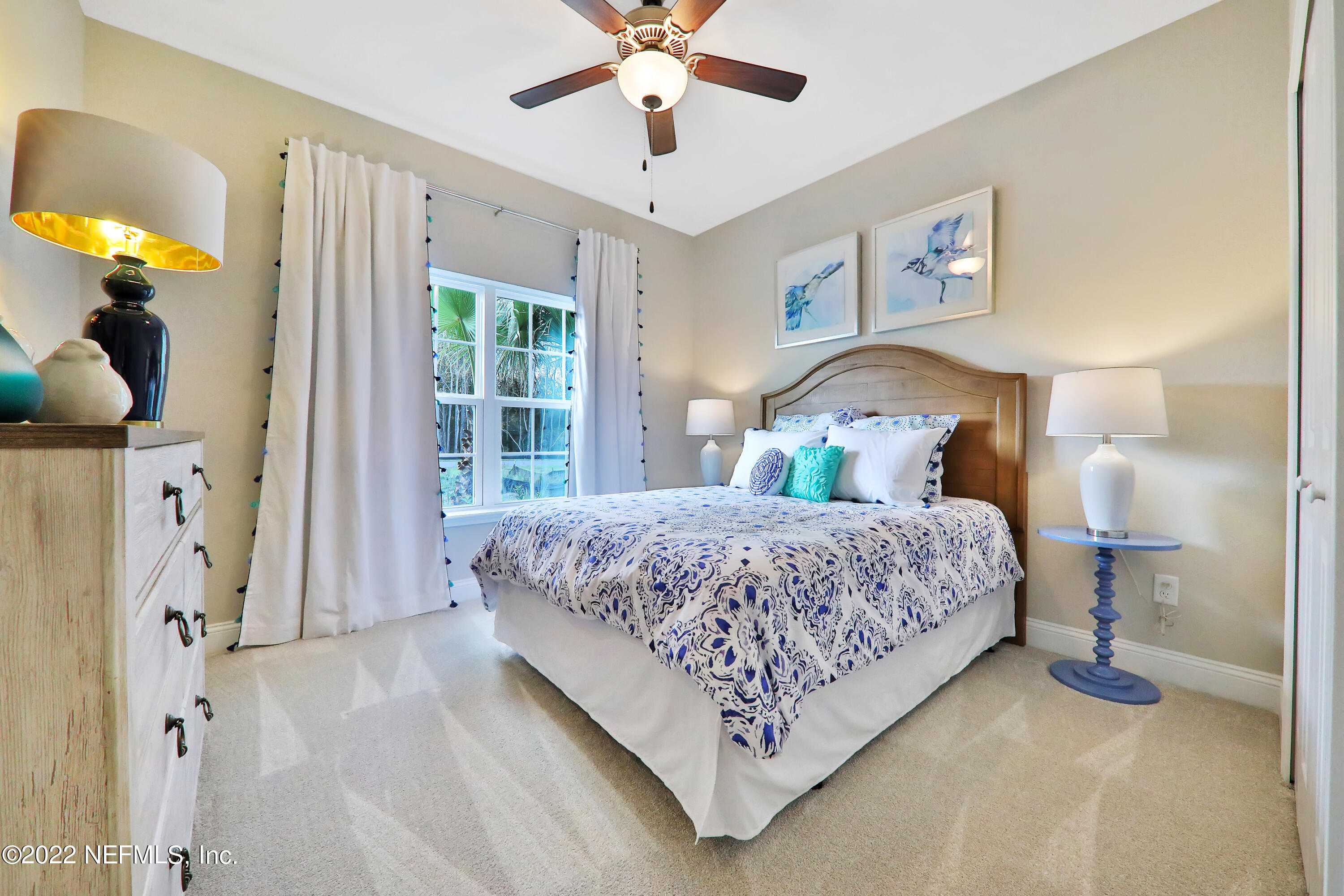 608 Ivory Palm Road Orange Park, FL 32073 - Photo 10 of 33 a bedroom with a bed chandelier and a window