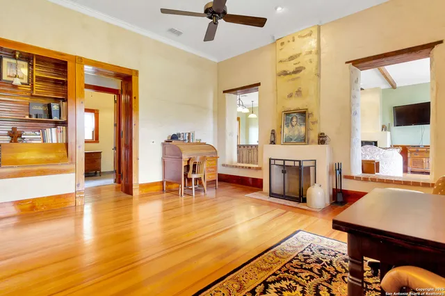 a living room with fireplace furniture and a table