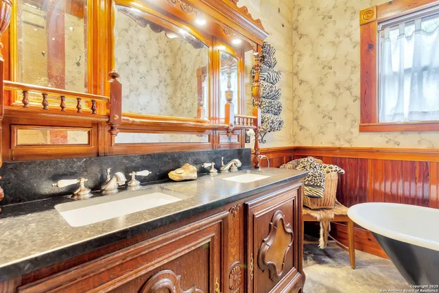 a bathroom with a sink and a large mirror