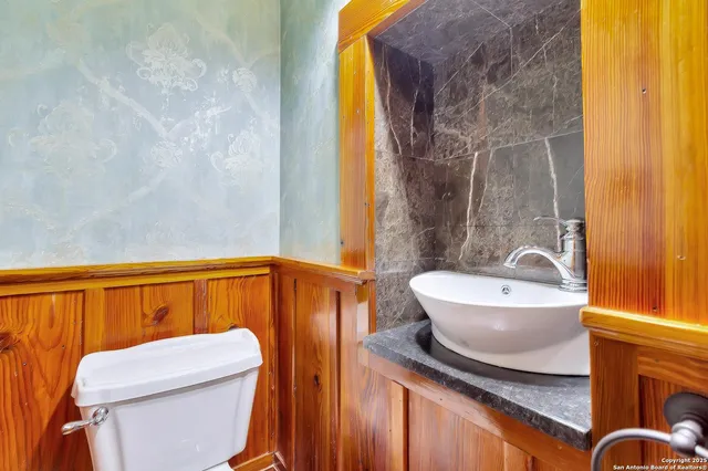 a utility room with stainless steel appliances cabinets and a window
