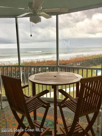 a view of a balcony with table and chairs