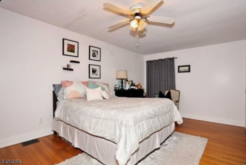 628 Second Avenue Lyndhurst, NJ 07071 - Photo 3 of 7 a bedroom with a large bed and a chandelier