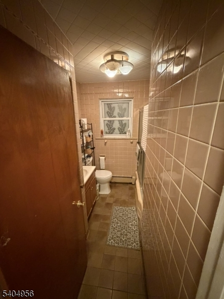 628 Second Avenue Lyndhurst, NJ 07071 - Photo 4 of 7 a bathroom with a sink a toilet and a mirror