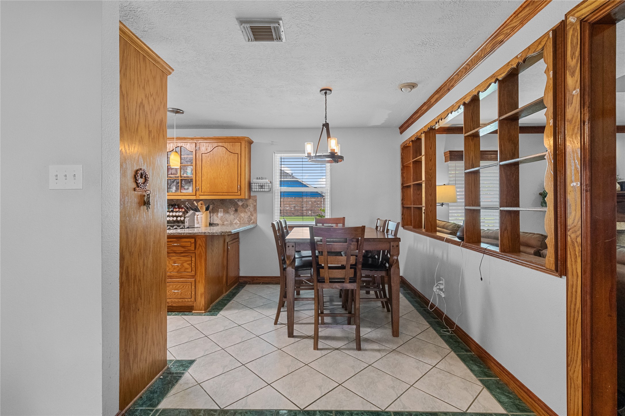 4322 Aztec Street Pasadena, TX 77504 - Photo 11 of 17 Enjoy meals with a view! This cozy dining space is filled with natural light and opens seamlessly to the kitchen.