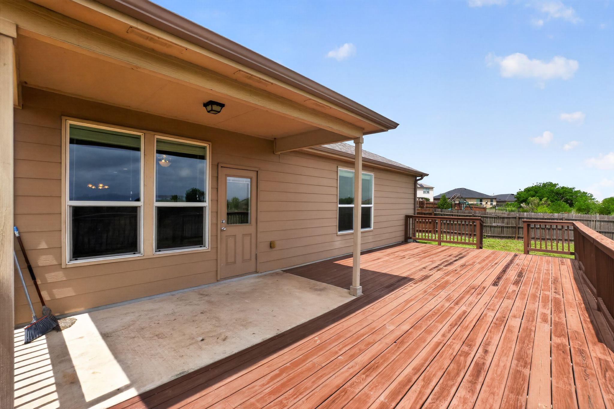 5816 Minch Road Austin, TX 78754 - Photo 12 of 15 The property features an expansive wooden deck, perfect for outdoor enjoyment, complemented by a covered patio area with a concrete surface